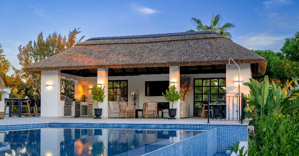 Cape Reed thatched roof sheltering a boho-themed outdoor kitchen and lounge in Elviria