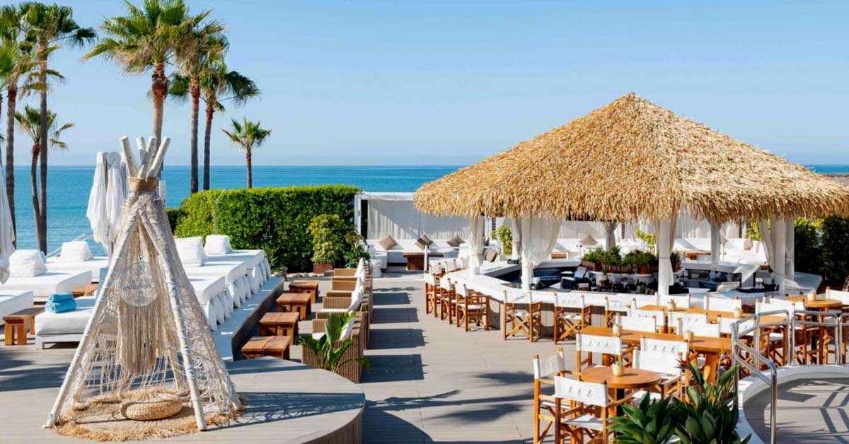 Cape Reed synthetic thatch Nikki Beach Marbella pool bar