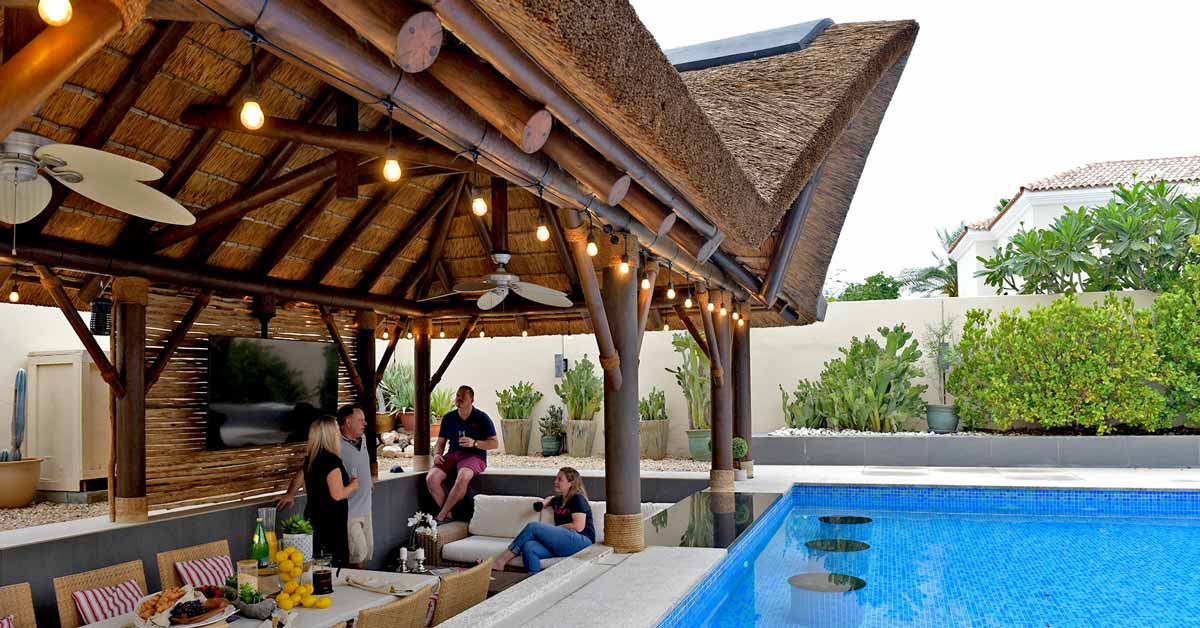 Sunken thatched gazebo with a swim-up poolbar.